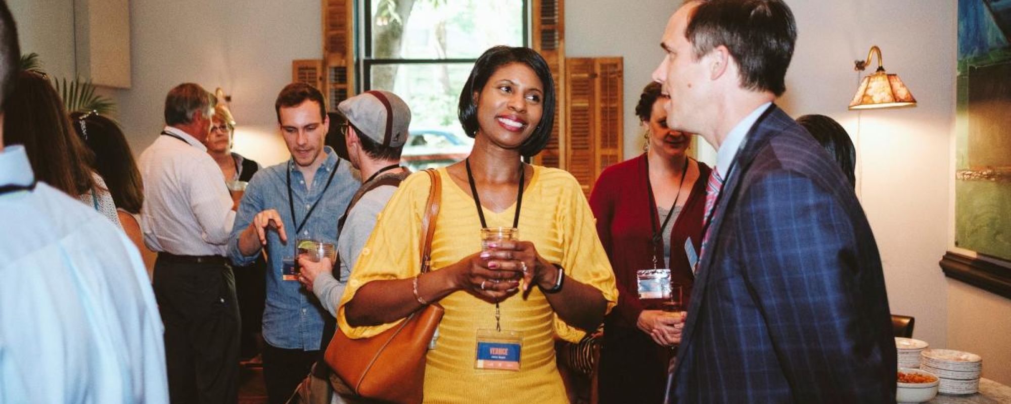 Community members chatting at a Go Connect networking event at the Charlottesville Common House