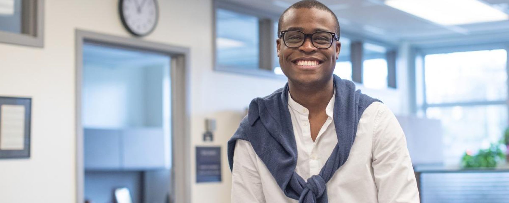 A male UVA employee smiling at the camera in an office setting