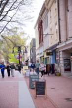 The Downtown Mall during the day with shoppers and runners and views of the stores and shops